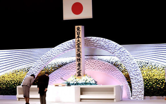 Japan's Emperor Naruhito, right, and Empress Masako bow in front of the altar for victims of the March 11, 2011 earthquake and tsunami at the national memorial service in Tokyo, Thursday, March 11, 2021.