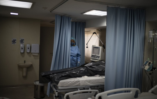 The body of a COVID-19 victim lies in a body bag at the ICU of the Sao Jose municipal hospital in Duque de Caxias, Brazil, Wednesday, March 24, 2021.