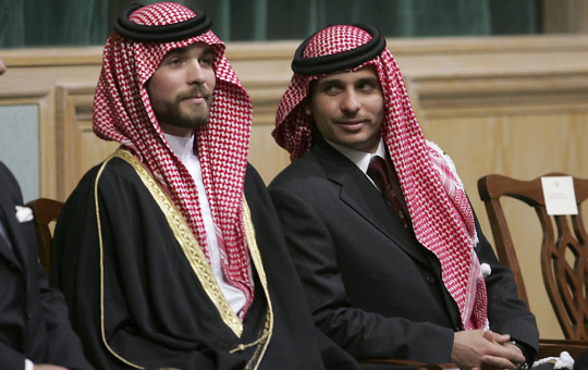 In this Tuesday, Nov. 28, 2006 file photo, Prince Hamza Bin Al-Hussein, right, and Prince Hashem Bin Al-Hussein, left, brothers of King Abdullah II of Jordan, attend the opening of the parliament in Amman, Jordan.