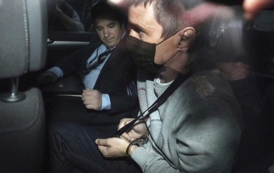 Richard Pusey, right, is taken away from his home property by police in Melbourne, Australia on April 23, 2020.