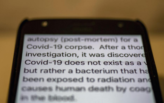 One of the scores of messages on COVID-19 getting circulated on WhatsApp is seen on a mobile phone in Dharmsala, India, Wednesday, May 12, 2021.