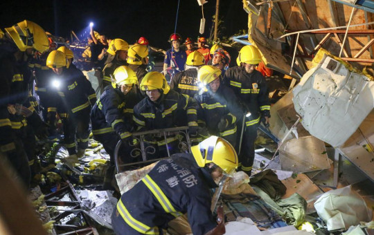 In this photo released by China's Xinhua News Agency, emergency personnel search through the wreckage of buildings destroyed by a reported tornado in Wuhan in central China's Hubei Province, early Saturday, May 15, 2021.