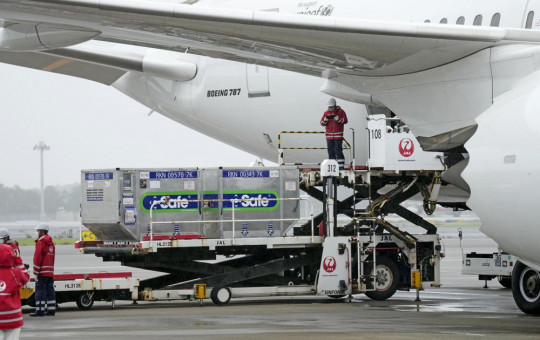 The containers carrying the coronavirus vaccines donated by Japanese government, are loaded to a plane before its departure for Taiwan, at Narita International Airport in Narita, east of Tokyo, Friday, June 4, 2021.