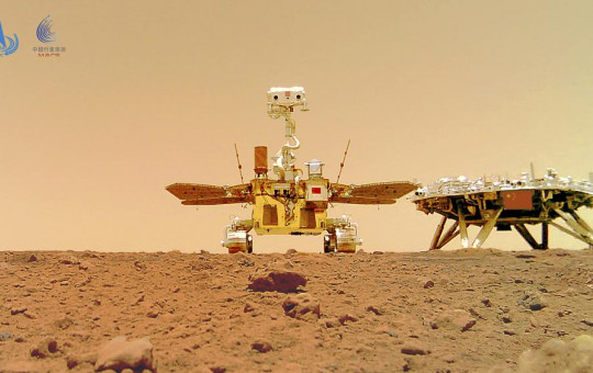 In this image released by the China National Space Administration (CNSA) on Friday, June 11, 2021, the Chinese Mars rover Zhurong is seen near its landing platform taken by a remote camera that was dropped into position by the rover.
