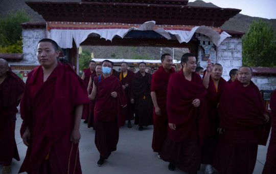 Monks prepare to go to dinner at the Tibetan Buddhist College near Lhasa in western China's Tibet Autonomous Region, Monday, May 31, 2021, as seen during a government organized visit for foreign journalists.