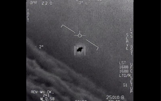 The image from video provided by the Department of Defense labelled Gimbal, from 2015, an unexplained object is seen at center as it is tracked as it soars high along the clouds, traveling against the wind.