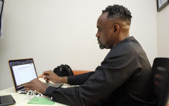 Dr. Ifeanyi Nsofor works on his laptop inside his office in Abuja, Nigeria, Monday, July 12, 2020.