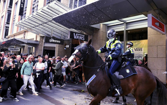 Protesters and mounted police clash at Sydney Town Hall during a 'World Wide Rally For Freedom' anti-lockdown rally in Sydney, Saturday, July 24, 2021.