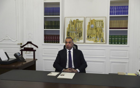 Iraqi Prime Minister Mustafa al-Kadhimi poses in his office during an interview with The Associated Press in Baghdad, Iraq, Friday, July 23, 2021.