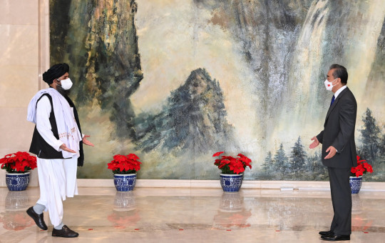 Chinese Foreign Minister Wang Yi (R) with senior Taliban leader Mullah Abdul Ghani Baradar.