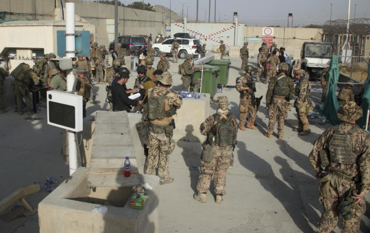 In this photo provided by the Ministry of Defence, members of the British and US military engage in the evacuation of people out of Kabul, Afghanistan on Friday, Aug. 20, 2021.
