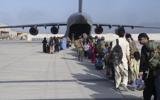 U.S. Air Force loadmasters and pilots assigned to the 816th Expeditionary Airlift Squadron, load people being evacuated from Afghanistan onto a U.S. Air Force C-17 Globemaster III at Hamid Karzai International Airport in Kabul on Tuesday.