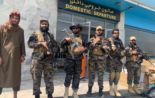 Taliban fighters stand guard inside the Hamid Karzai International Airport after the U.S. withdrawal in Kabul, Afghanistan, Tuesday, Aug. 31, 2021.