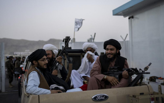 Taliban fighters sit in a pickup truck at the airport in Kabul, Afghanistan, Thursday, Sept. 9, 2021.