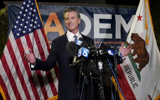 California Gov. Gavin Newsom addresses reporters after beating back the recall attempt that aimed to remove him from office, at the John L. Burton California Democratic Party headquarters in Sacramento, California