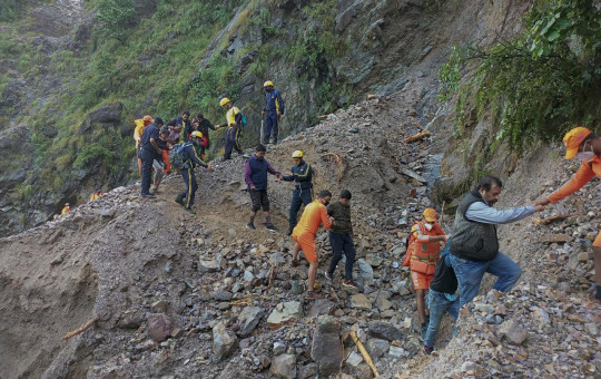 This photograph provided by India’s National Disaster Response Force (NDRF) shows NDRF personnel rescuing civilians stranded following heavy rains at Chhara village near Nainital, Uttarakhand, Wednesday, Oct. 20, 2021.