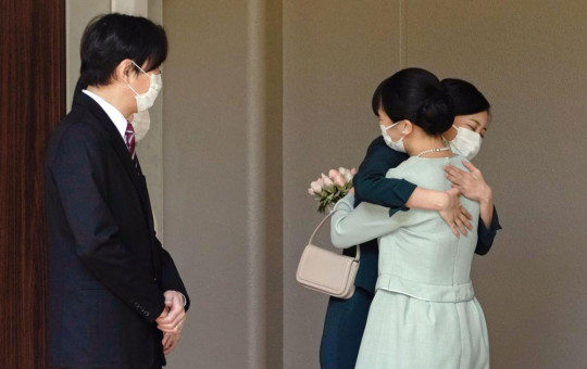 Japan's Princess Mako, right, hugs her sister Princess Kako, watched by her parents Crown Prince Akishino and Crown Princess Kiko, before leaving her home in Akasaka Estate in Tokyo Tuesday, Oct. 26, 2021.