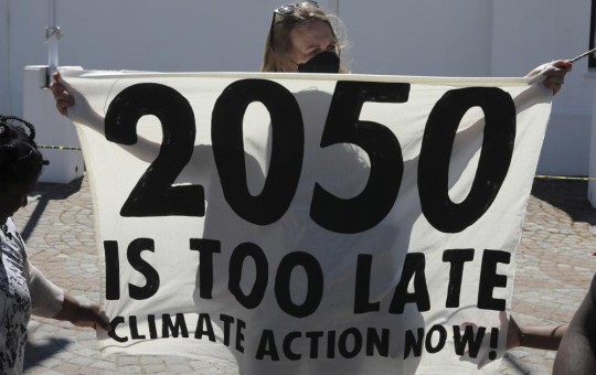 Activists protest for climate justice outside parliament in Cape Town, South Africa, Tuesday, Nov. 9, 2021. The protests coincides with the second week of as the COP26, UN Climate Summit in Glasgow.