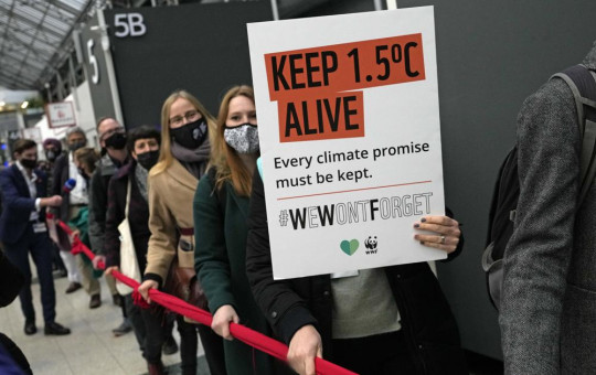 Climate activists hold a demonstration through the venue of the COP26 U.N. Climate Summit in Glasgow, Scotland, Friday, Nov. 12, 2021.