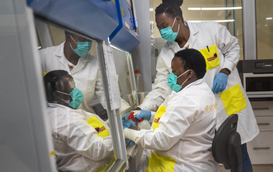 Melva Mlambo, right, and Puseletso Lesofi, both medical scientists prepare to sequence COVID-19 omicron samples at the Ndlovu Research Center in Elandsdoorn, South Africa, Dec. 8, 2021.
