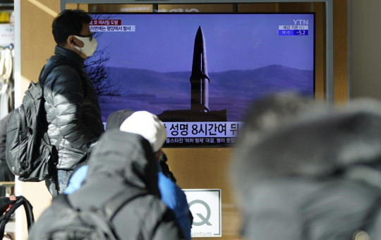 People watch a TV screen showing a news program reporting about North Korea's missile launch with a file image, at a train station in Seoul, South Korea, Monday, Jan. 17, 2022.