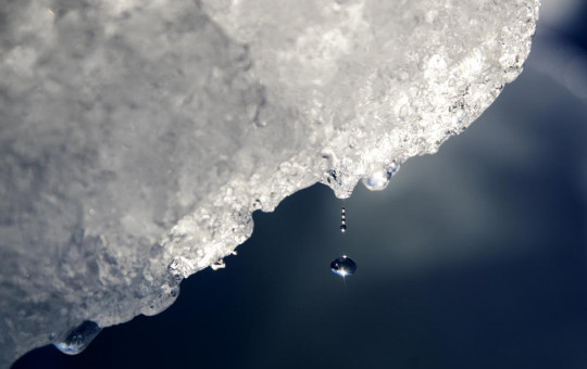 A drop of water falls off an iceberg melting in the Nuup Kangerlua Fjord near Nuuk in southwestern Greenland, Tuesday, Aug. 1, 2017.