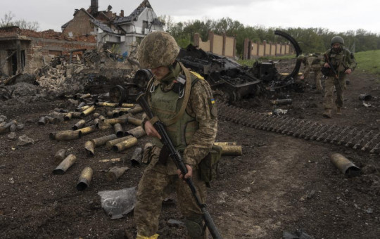 Ukrainian servicemen patrol in a recently retaken village, north of Kharkiv, east Ukraine, Sunday, May 15, 2022.