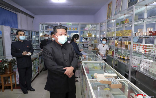 In this photo provided by the North Korean government, North Korean leader Kim Jong Un, center, visits a pharmacy in Pyongyang, North Korea on May 15, 2022.