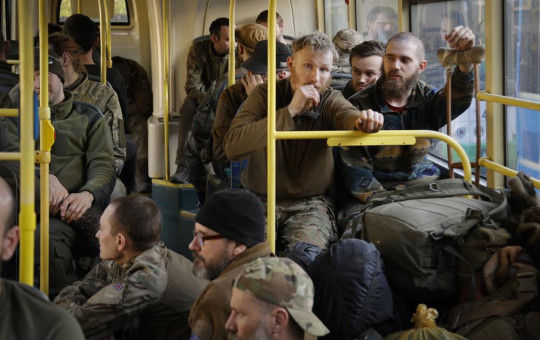 Ukrainian servicemen sit in a bus after they were evacuated from the besieged Mariupol's Azovstal steel plant, near a remand prison in Olyonivka, in territory under the government of the Donetsk People's Republic, eastern Ukraine, Tuesday.