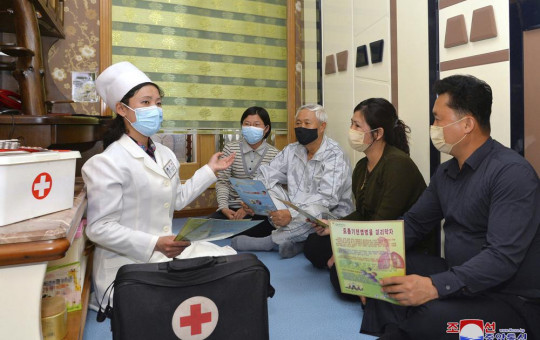 In this photo provided by the North Korean government, a doctor visits a family during an activity to raise public awareness of the COVID-19 prevention measures, in Pyongyang, North Korea Tuesday, May 17, 2022.