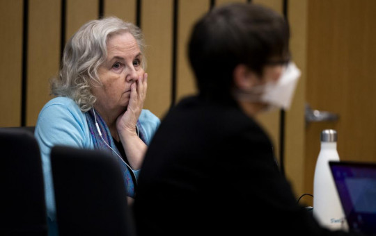 FILE - Romance writer Nancy Crampton Brophy, left, accused of killing her husband, Dan Brophy, in June 2018, watches proceedings in court in Portland, Ore., Monday, April 4, 2022.