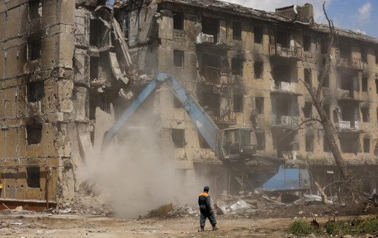 Russian Emergency Situations Ministry workers disassemble a destroyed building in Mariupol, in territory under the government of the Donetsk People's Republic, eastern Ukraine, Friday, May 27, 2022.