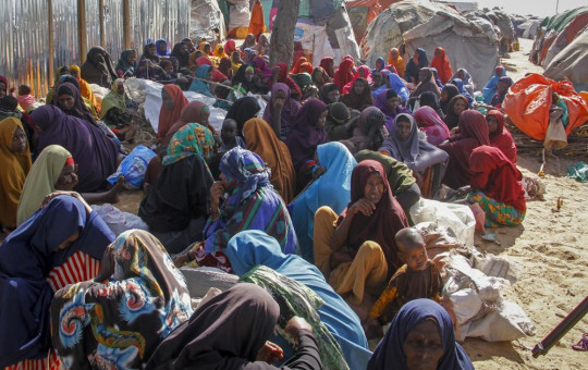 FILE - Somalis who fled drought-stricken areas sit at a makeshift camp on the outskirts of the capital Mogadishu, Somalia on Feb. 4, 2022.