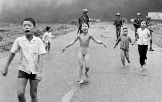 FILE - South Vietnamese forces follow terrified children, including 9-year-old Kim Phuc, center, as they run down Route 1 near Trang Bang after an aerial napalm attack on suspected Viet Cong hiding places on June 8, 1972. (AP Photo/Nick Ut, File)