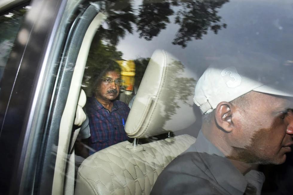 FILE- Arvind Kejriwal, leader of the Aam Admi Party, or Common Man’s Party, left, leaves in a car after a court extended his custody for four more days, in New Delhi, India, March 28, 2024. (AP Photo)