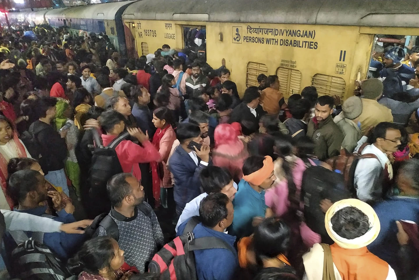 Passengers jostle with each other to board a train at the New Delhi Railway station, in New Delhi, India, Thursday, Feb.15, 2025. AP/RSS Photo)