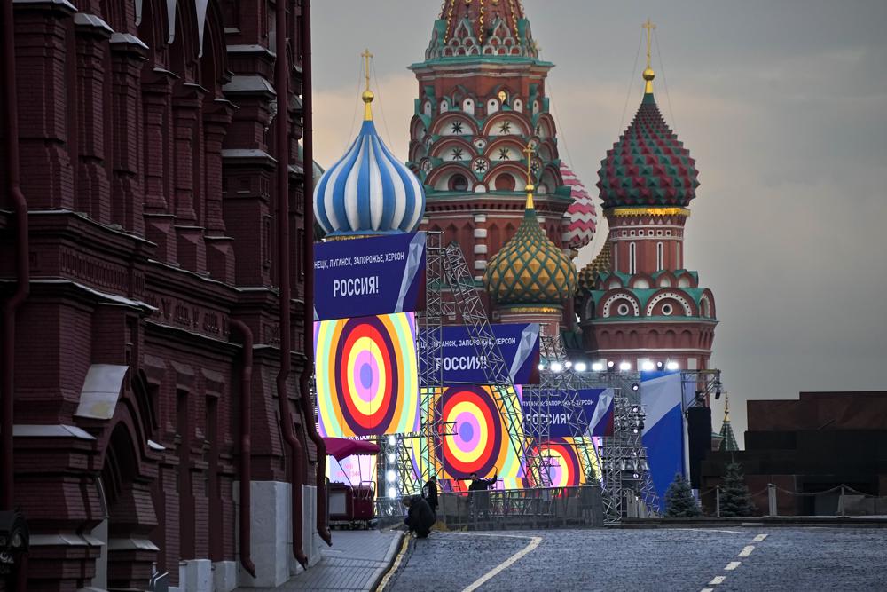 People make preparations for a concert at the Red Square, with constructions reading the words ''Donetsk, Luhansk, Zaporizhzhia, Kherson, Russia'', and the St. Basil's Cathedral and Lenin Mausoleum on the background, in Moscow, Russia, Thursday, Sept 29, 2022. (AP/RSS Photo)