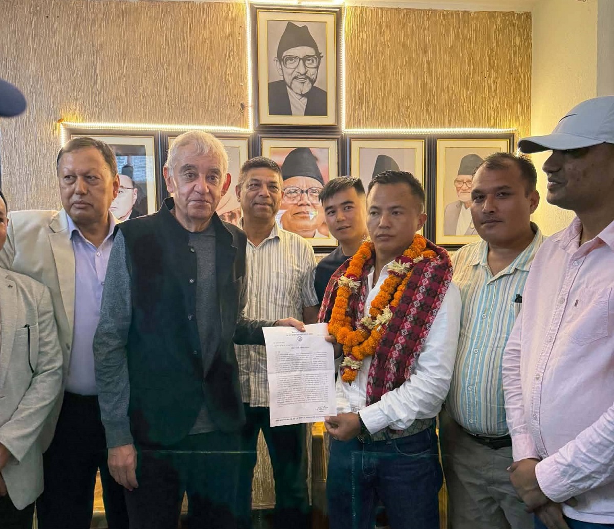 Coordinator Shashank Koirala hands Lal Kaji Tamang the appointment letter as Sindhupalchowk district coordinator.