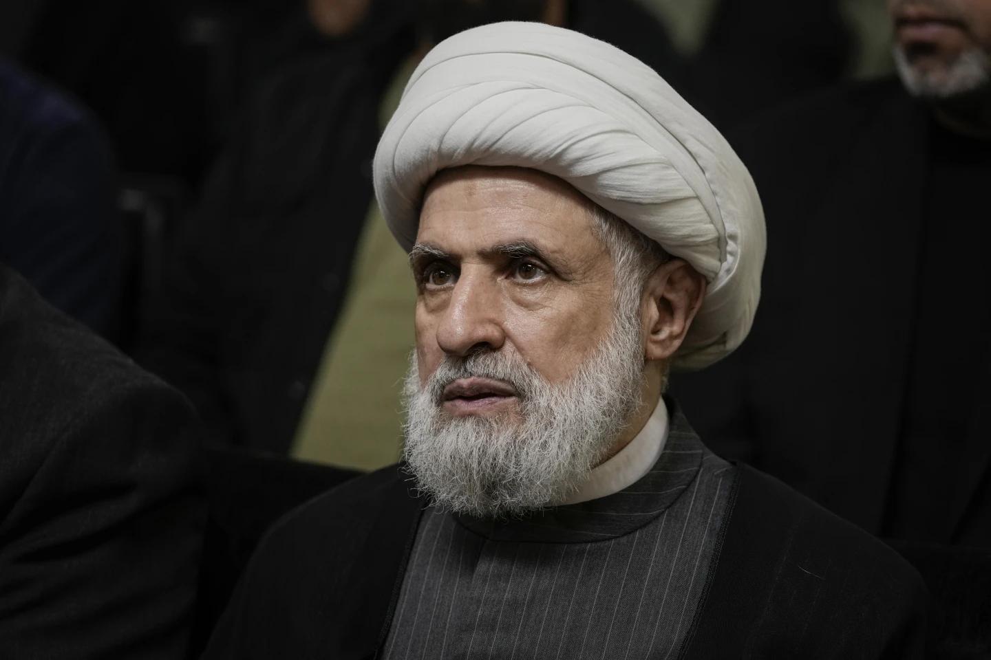 FILE - Hezbollah’s deputy leader, Sheikh Naim Kassem, listens to a speech by then-leader Hassan Nasrallah on a screen in southern Beirut, Wednesday, June 19, 2024. (AP Photo)