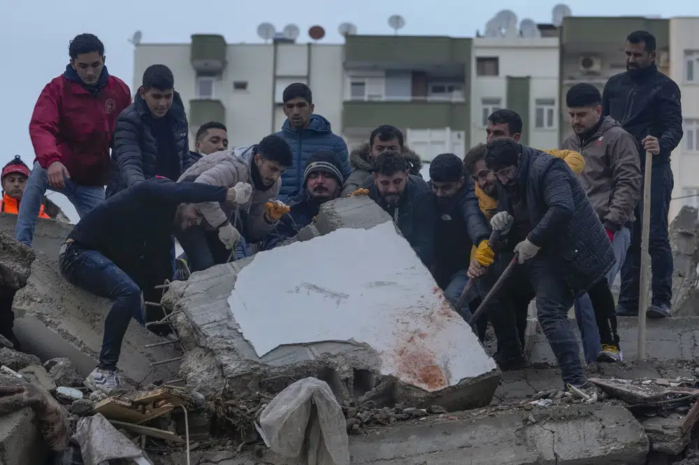 Men search for people among the debris in a destroyed building in Adana, Turkey, Monday, Feb. 6, 2023. A powerful quake has knocked down multiple buildings in southeast Turkey and Syria and many casualties are feared. AP/RSS Photo