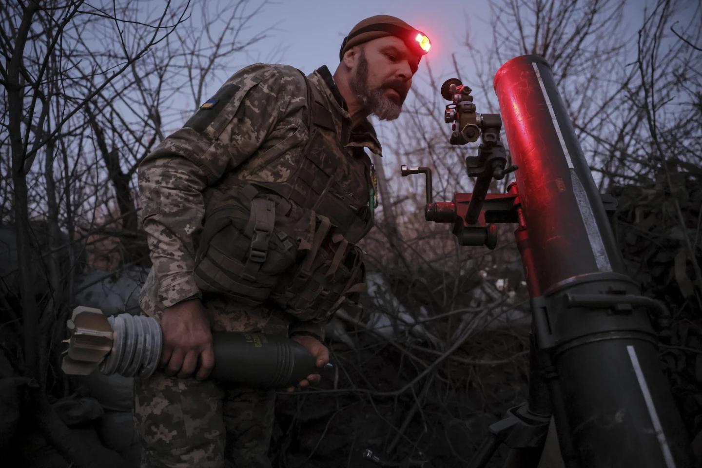 In this photo provided by Ukraine’s 24th Mechanised Brigade press service, a serviceman of the 24th Mechanised Brigade prepares to fire 120mm mortar towards Russian positions near Chasiv Yar town, in Donetsk region, Ukraine, Tuesday, Nov. 19, 2024. (AP)