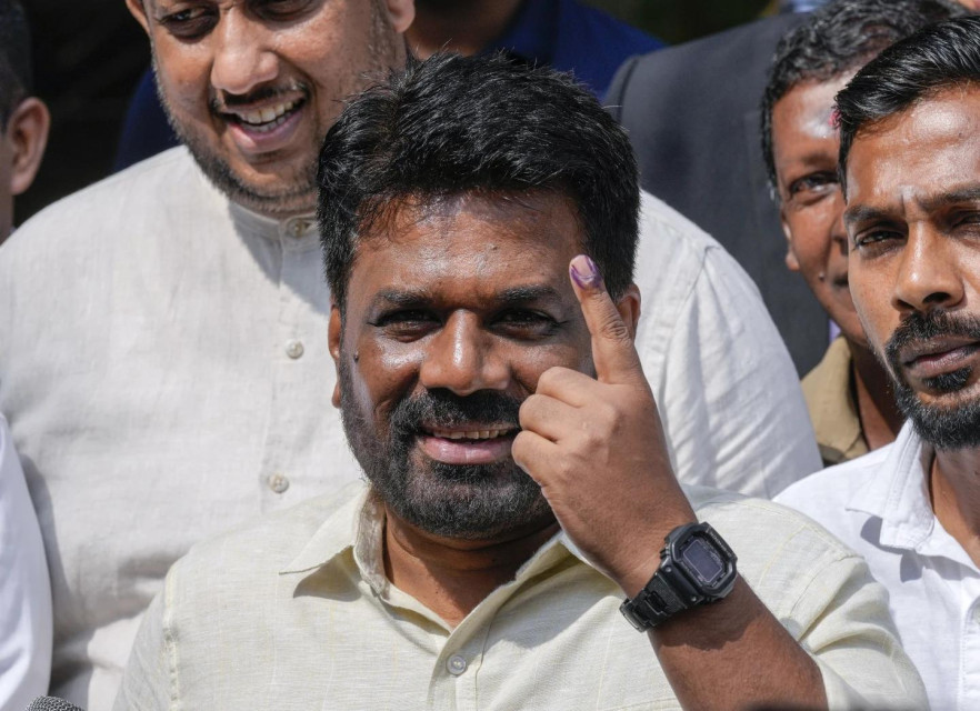 Sri Lankan President Anura Kumara Dissanayake shows his finger as he leaves after casting his vote during the parliamentary election in Colombo, Sri Lanka, Thursday, Nov. 14, 2024.(AP Photo)