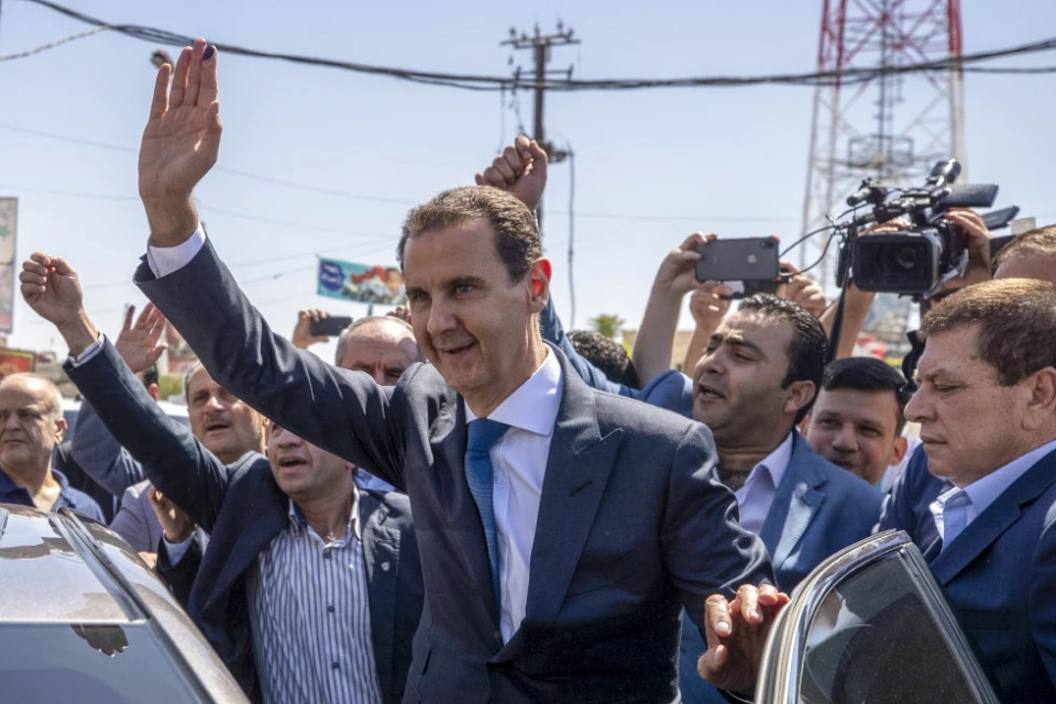 FILE - Syrian President Bashar Assad, center, waves to his supporters at a polling station during the Presidential elections in the town of Douma, in the eastern Ghouta region, near the Syrian capital Damascus, Syria, May 26, 2021. (AP/RSS Photo)