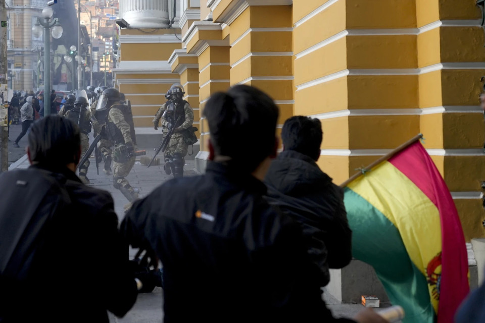 Supporters of President Luis Arce chase soldiers as they flee from Plaza Murillo, after a failed coup attempt in La Paz, Bolivia, Wednesday, June 26, 2024. AP/RSS Photo