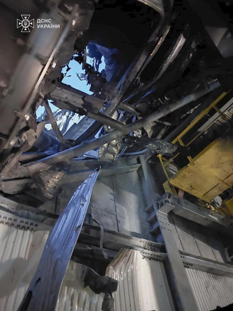 In this photo provided by the Ukrainian Emergency Service, a searchlight illuminates a hole in the roof of a damaged sarcophagus, that covers the destroyed 4th reactor of Chernobyl nuclear power plant, following a Russian drone attack in Chernobyl, Ukraine, Friday, Feb. 14, 2025. (AP)