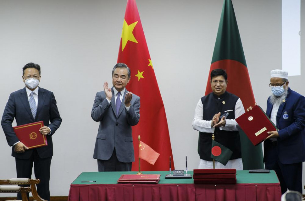 Chinese Foreign Minister Wang Yi, center left, and his Bangladeshi counterpart A.K. Abdul Momen applaud as both countries sign agreements in Dhaka, Bangladesh, Sunday, Aug.7, 2022.  AP/RSS Photo
