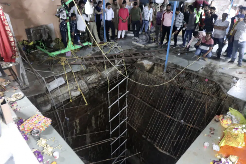 People stand around a structure built over an old temple well that collapsed Thursday as a large crowd of devotees gathered for the Ram Navami Hindu festival in Indore, India, Thursday, March 30, 2023. AP/RSS Photo