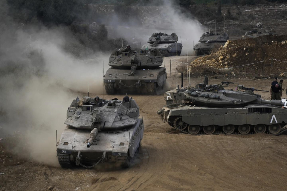 Israeli army tanks manoeuvre in a staging area in northern Israel near the Israel-Lebanon border, Tuesday, Oct. 1, 2024. (AP Photo)