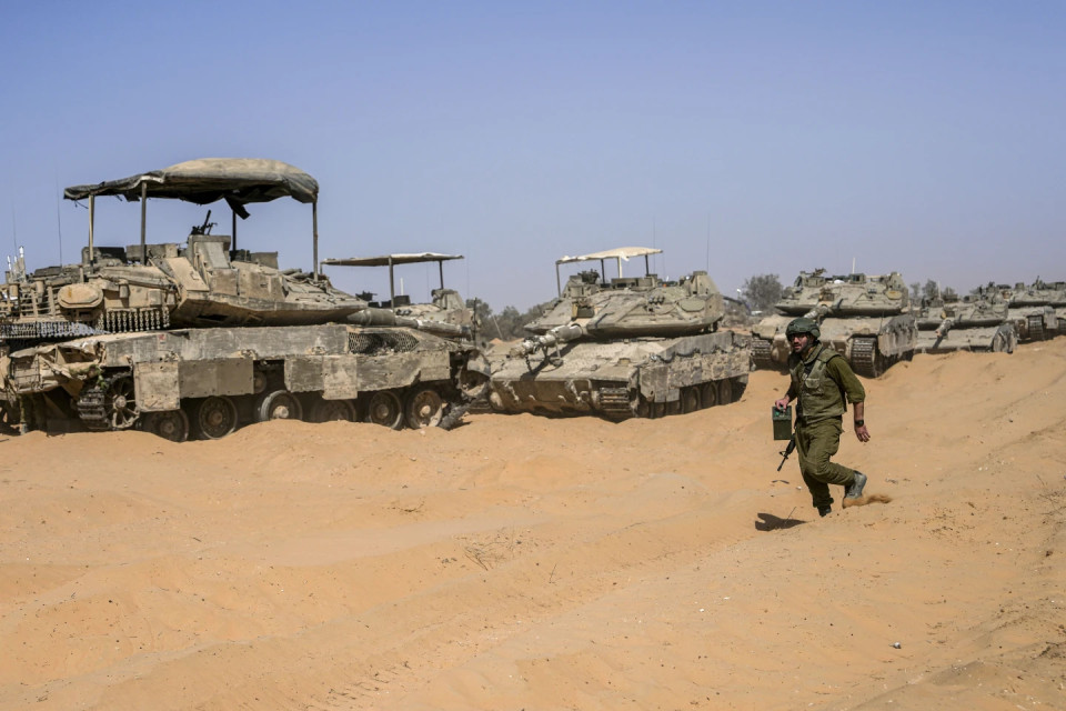 An Israeli soldier walks past a line of tanks at a staging ground near the border with the Gaza Strip, in southern Israel, Sunday, May 5, 2024. AP/RSS Photo