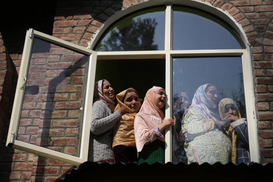 Relatives and neighbors cry as they watch the funeral of Kashmiri doctor Shahnawaz who was among those killed when gunmen fired at people working on a strategic tunnel project in Indian-controlled Kashmir, at Nadigam village, southwest of Srinagar, Monday, Oct. 21, 2024. (AP Photo)